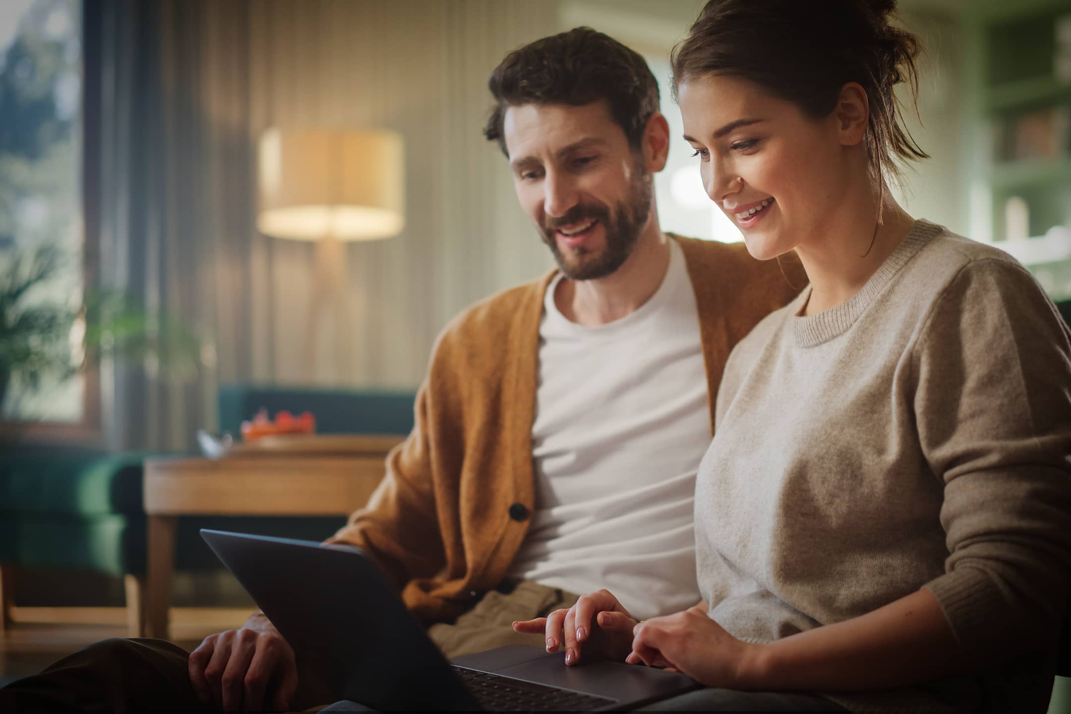 Couple sitting with their computer
