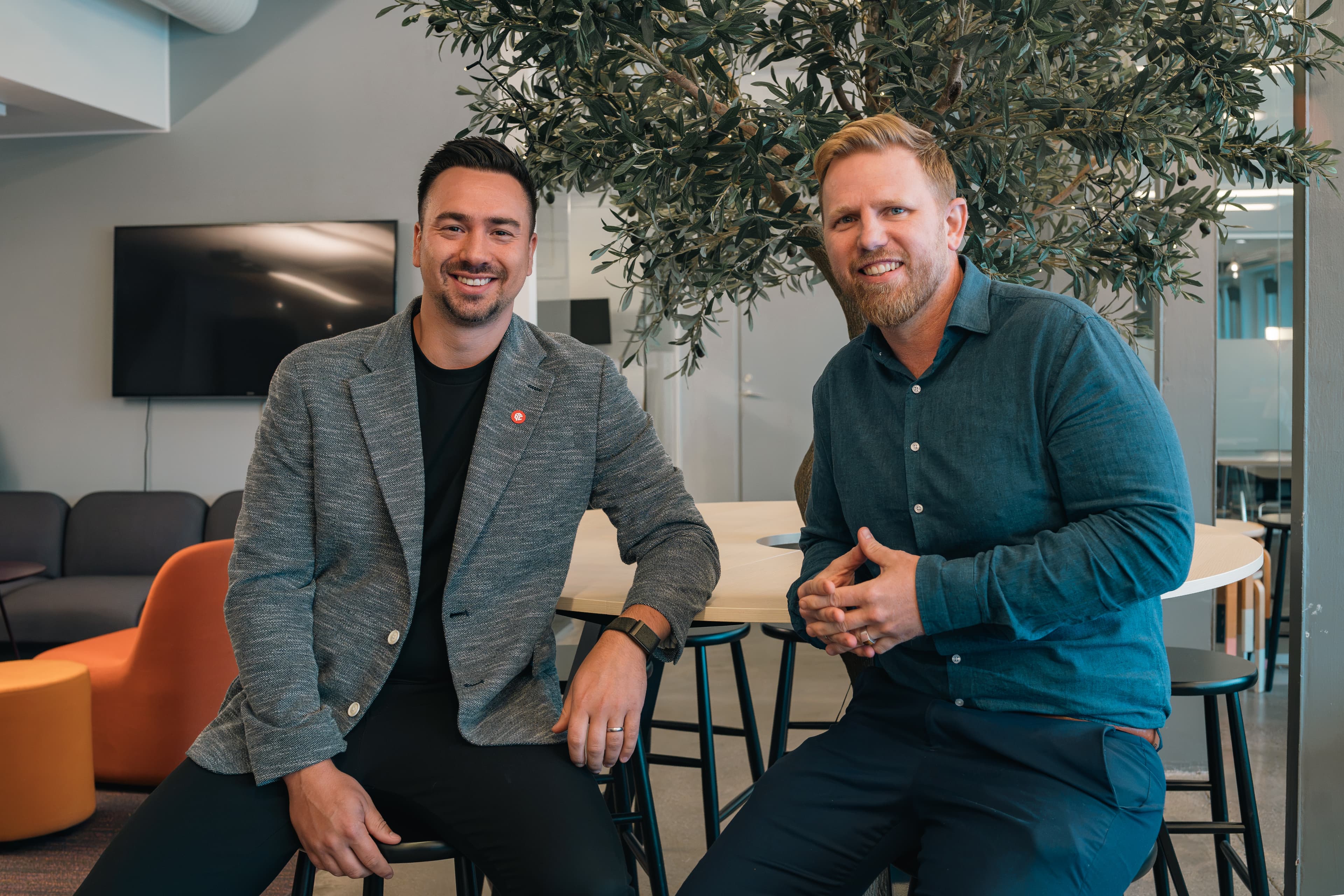 CEO of AQC Behrooz Mirahmadi sits with Scrive CRO Viktor Wrede in Scrive's Stockholm office